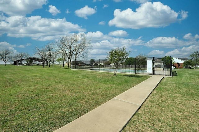 view of home's community featuring a pool and a lawn