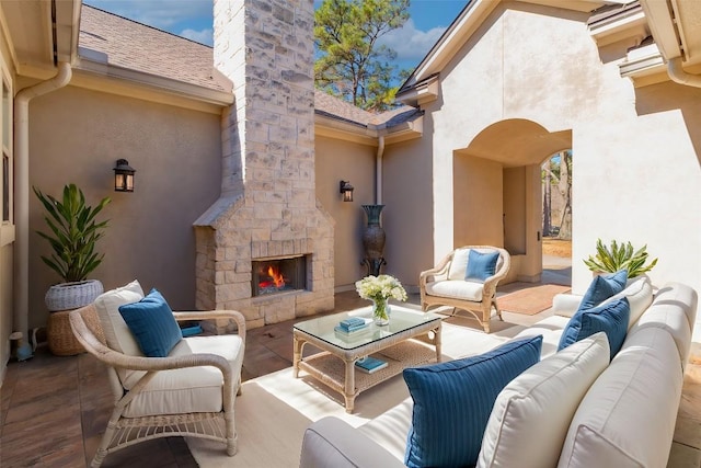 view of patio / terrace featuring an outdoor living space with a fireplace