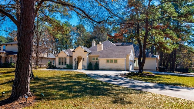 view of front of home featuring a garage and a front lawn