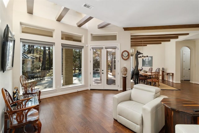 sitting room featuring dark wood-type flooring, beam ceiling, and french doors