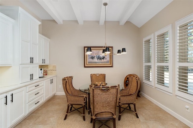 dining room featuring light tile patterned floors and lofted ceiling with beams