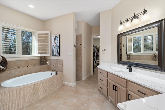 bathroom featuring vanity, tiled bath, and tile patterned floors