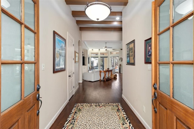 entrance foyer with beam ceiling, dark wood-type flooring, and ceiling fan