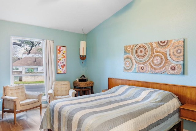 bedroom with vaulted ceiling and wood-type flooring