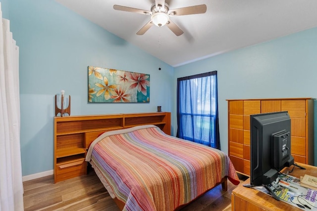 bedroom featuring hardwood / wood-style flooring, lofted ceiling, and ceiling fan