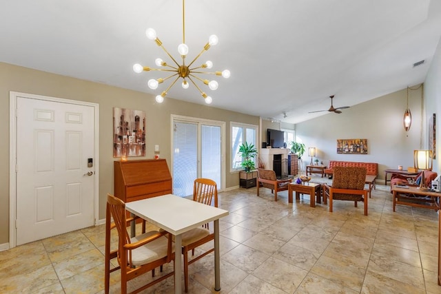 dining area featuring lofted ceiling, ceiling fan with notable chandelier, and light tile patterned floors