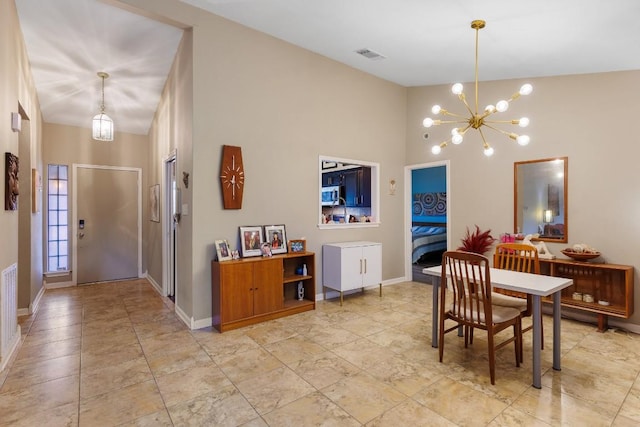 dining room featuring high vaulted ceiling and a notable chandelier