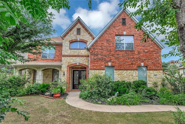 view of front of house with a front lawn and french doors