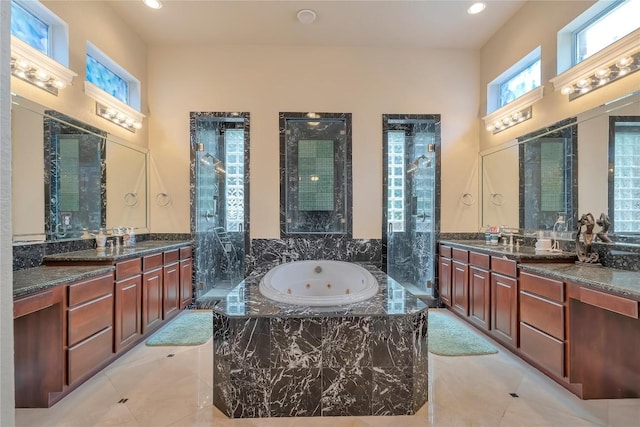 bathroom with vanity, tile patterned floors, and plus walk in shower