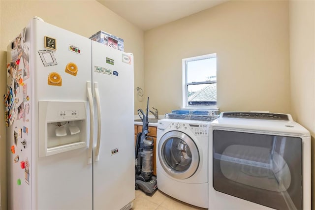 laundry area featuring washer and dryer and light tile patterned floors