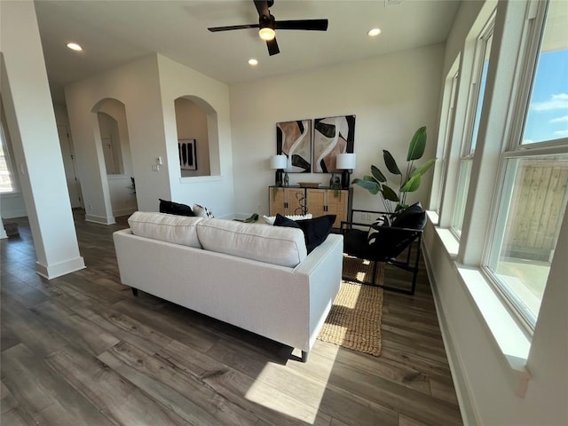 living room featuring dark hardwood / wood-style floors and ceiling fan