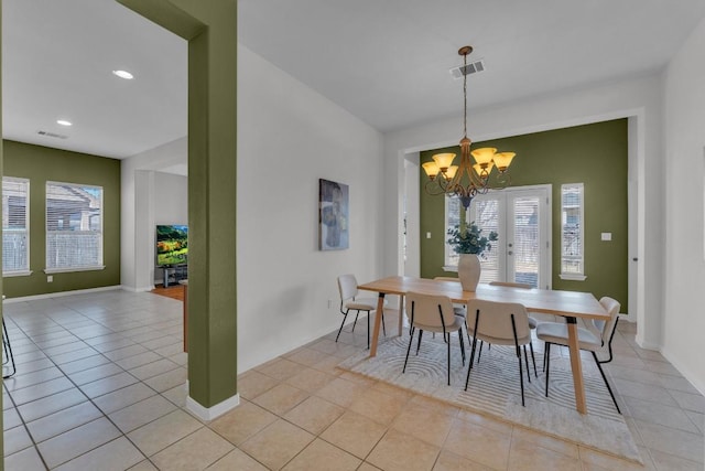 dining area featuring light tile patterned flooring, french doors, and a notable chandelier