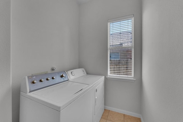 laundry area with light tile patterned floors, plenty of natural light, and independent washer and dryer