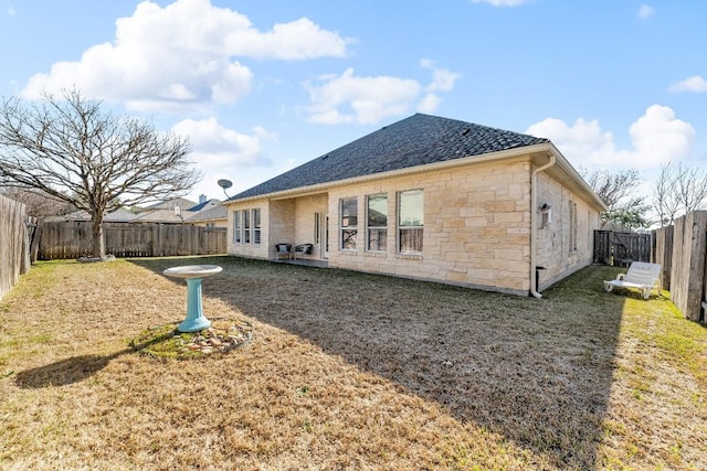 back of house featuring a lawn