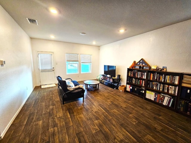 living area featuring dark hardwood / wood-style floors and a textured ceiling