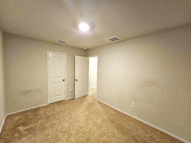 spare room with light carpet