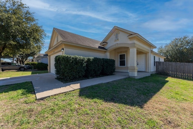 view of front of property with a garage and a front yard