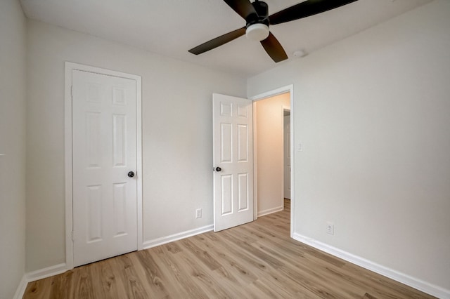 unfurnished bedroom with ceiling fan and light wood-type flooring