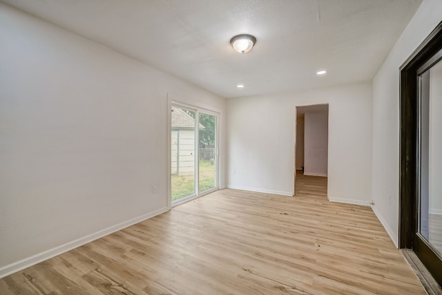 unfurnished room with light hardwood / wood-style flooring