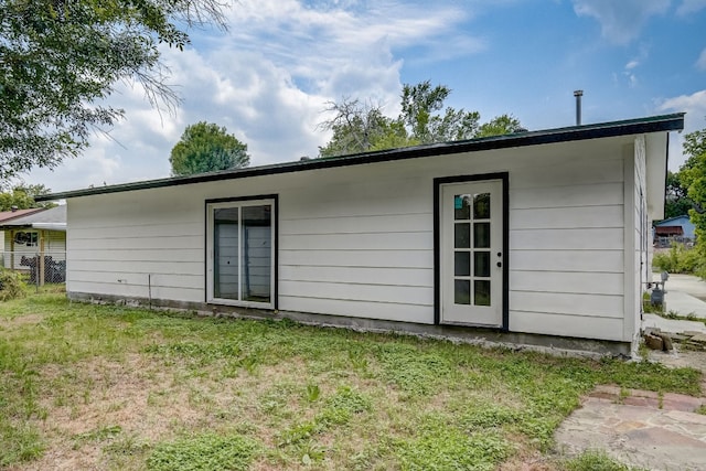 rear view of property with a yard