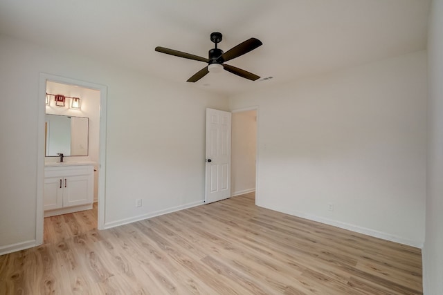 unfurnished bedroom with sink, ensuite bath, light hardwood / wood-style floors, and ceiling fan