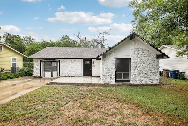 6009 Glen Meadow Dr, Austin, TX 78745 - back of property with stone siding and a lawn