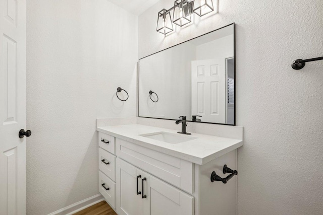 6009 Glen Meadow Dr, Austin, TX 78745 - bathroom featuring vanity and wood finished floors
