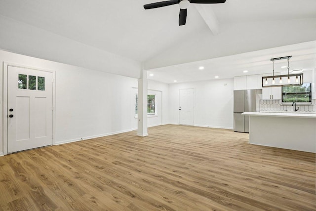 6009 Glen Meadow Dr, Austin, TX 78745 - unfurnished living room featuring light wood-style floors, plenty of natural light, and recessed lighting