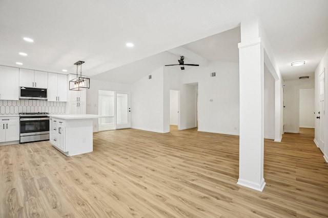 6009 Glen Meadow Dr, Austin, TX 78745 - kitchen with stainless steel appliances, white cabinetry, light countertops, light wood-style floors, and recessed lighting