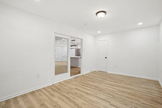 6009 Glen Meadow Dr, Austin, TX 78745 - empty room featuring light wood-type flooring, recessed lighting, and a chandelier