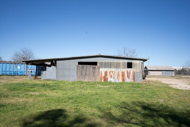 view of outbuilding featuring a lawn