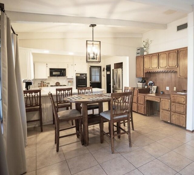 tiled dining room with lofted ceiling with beams and a chandelier