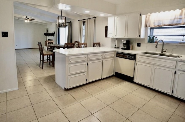 kitchen with dishwasher, sink, white cabinets, hanging light fixtures, and kitchen peninsula