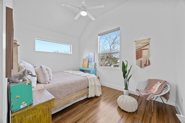 bedroom with baseboards, lofted ceiling, wood finished floors, and a ceiling fan