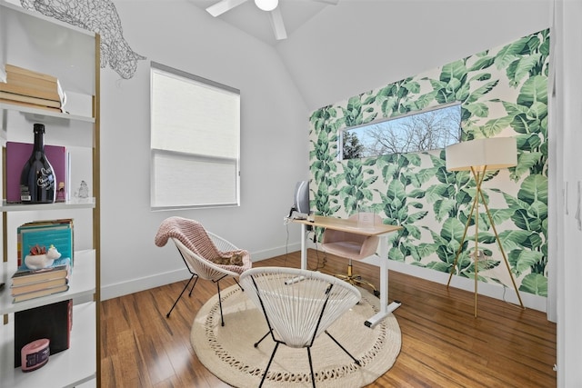 living area with vaulted ceiling, ceiling fan, baseboards, and wood finished floors