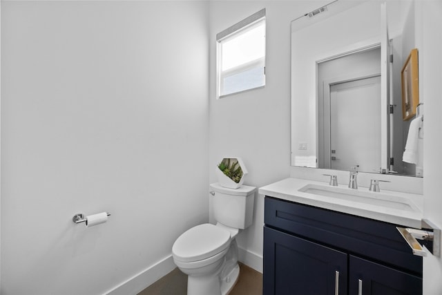 bathroom featuring visible vents, toilet, vanity, and baseboards