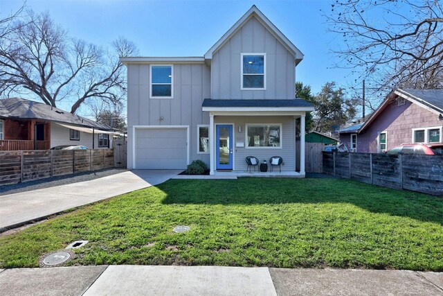 view of front of home with a garage, a front lawn, and a porch