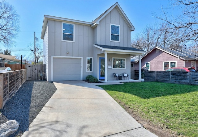 view of front facade featuring concrete driveway, fence, board and batten siding, and a front yard