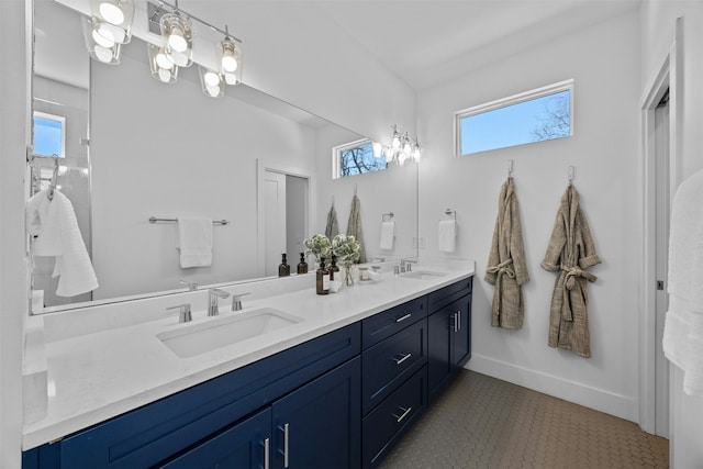 full bath with a wealth of natural light, double vanity, and a sink