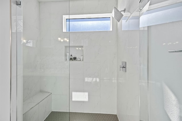 bathroom with tiled shower