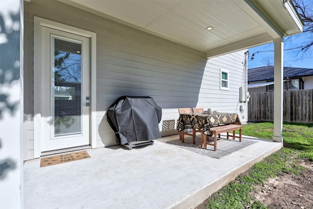 view of patio with area for grilling and fence