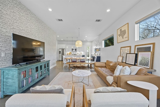 living area featuring recessed lighting and visible vents