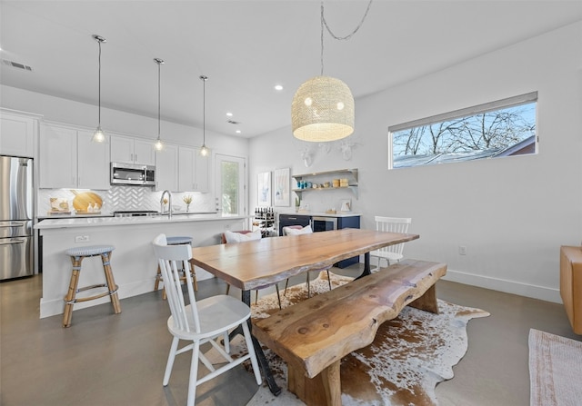 dining space with visible vents, recessed lighting, baseboards, and concrete floors