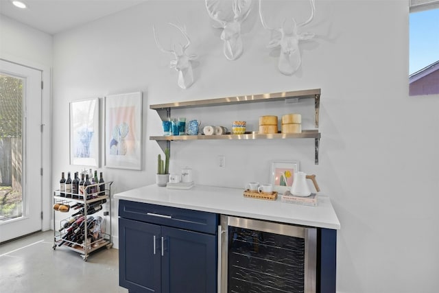 bar featuring wine cooler, recessed lighting, a dry bar, and concrete flooring