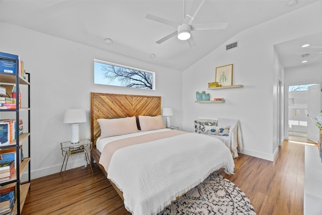 bedroom featuring visible vents, lofted ceiling, baseboards, and wood finished floors