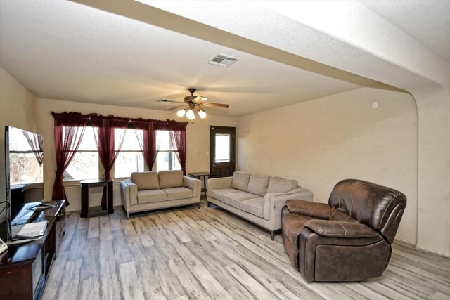 living room featuring ceiling fan and light hardwood / wood-style floors