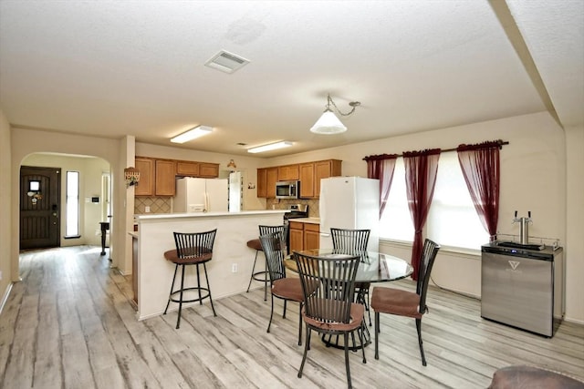 dining space featuring light wood-type flooring