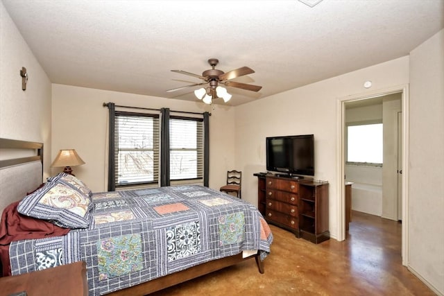 bedroom featuring ceiling fan, concrete flooring, and a textured ceiling