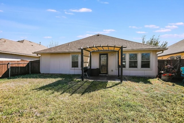 rear view of house with a patio and a lawn