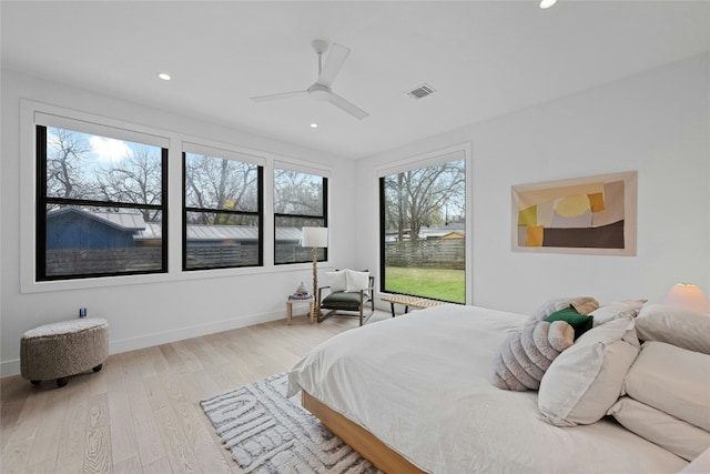 bedroom with light hardwood / wood-style floors and ceiling fan